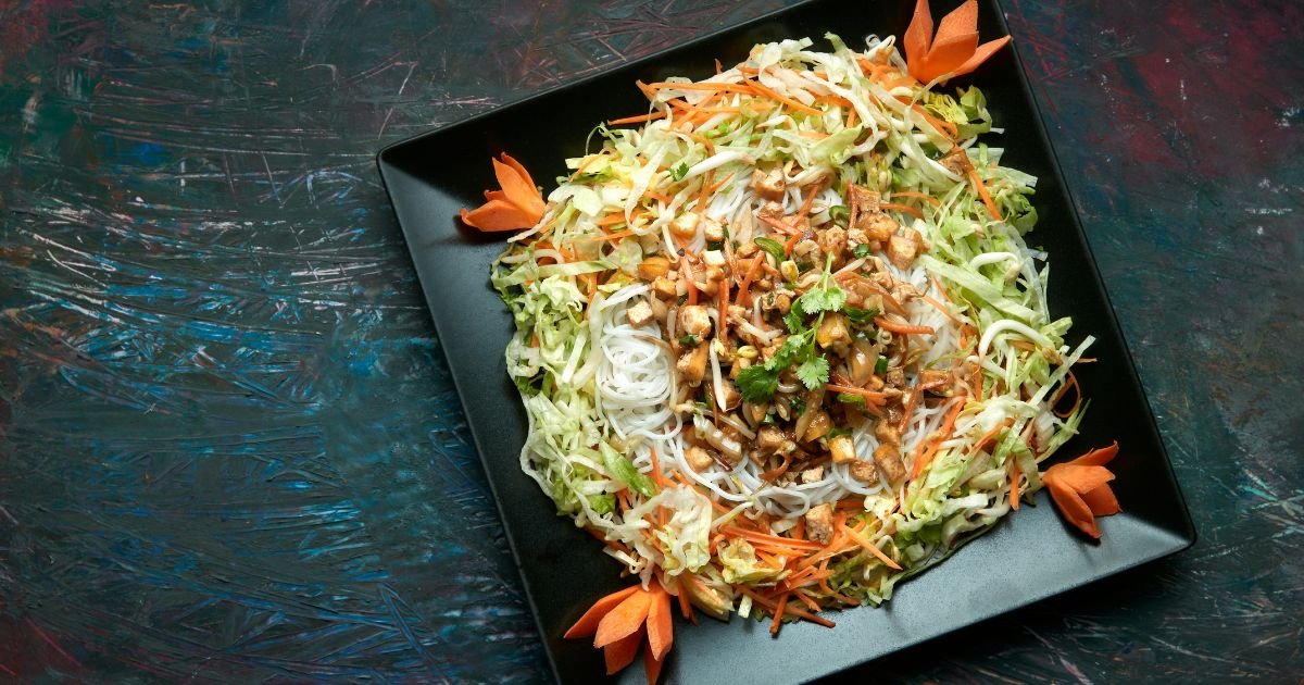 overhead view of chinese chicken salad on black dish on black table