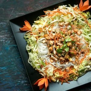 overhead view of chinese chicken salad on black dish on black table